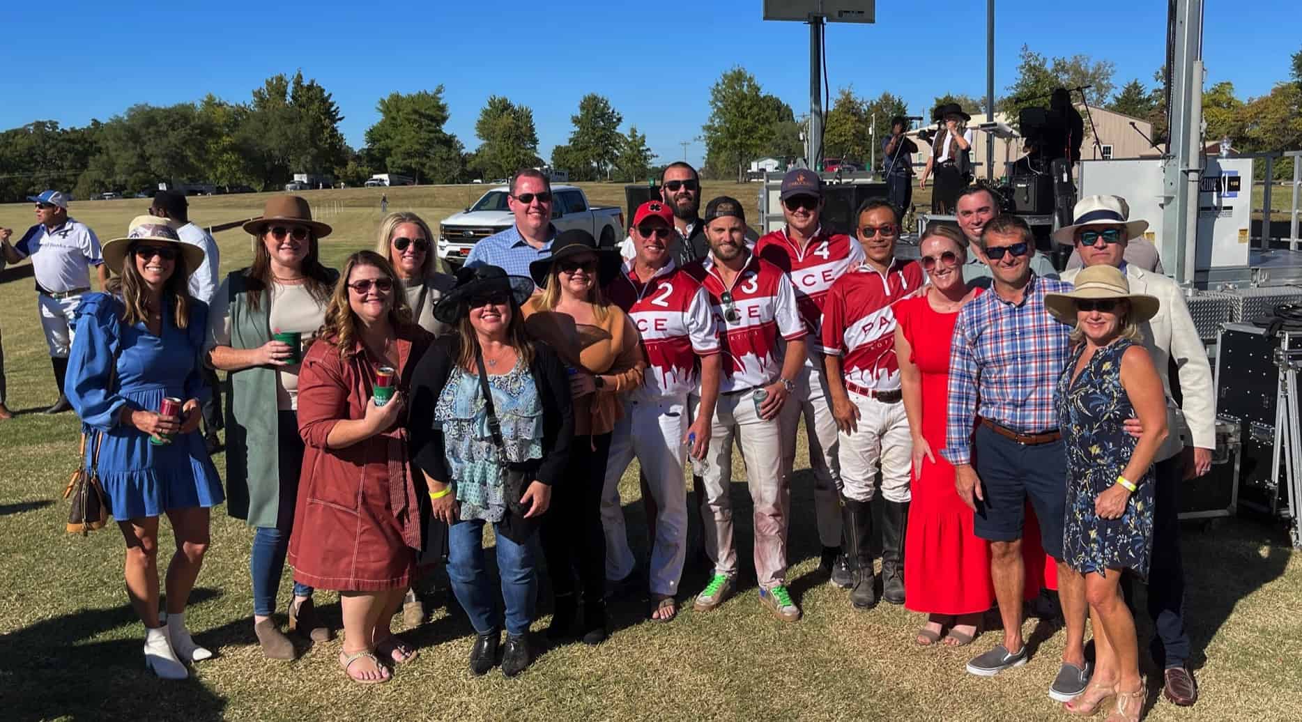 Pace team group photo with polo players at charity match